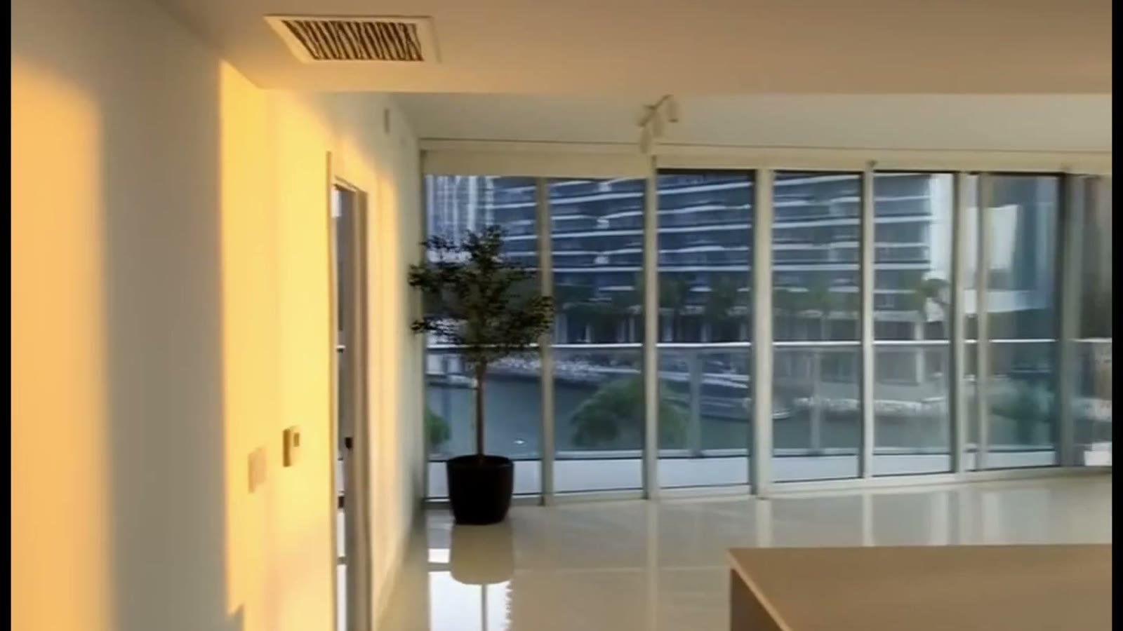 A frame from the first person walkthrough: an apartment living room, furnished, late afternoon.